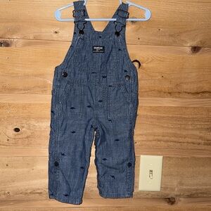 OshKosh 12M chambray blue with dinosaurs roll up legs snap crotch bib overalls